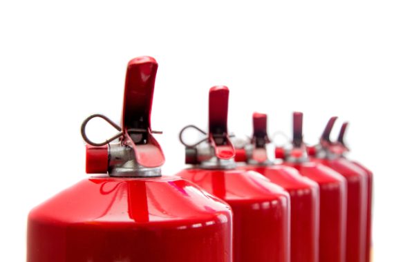 Fire extinguishers have been lined up in a row.