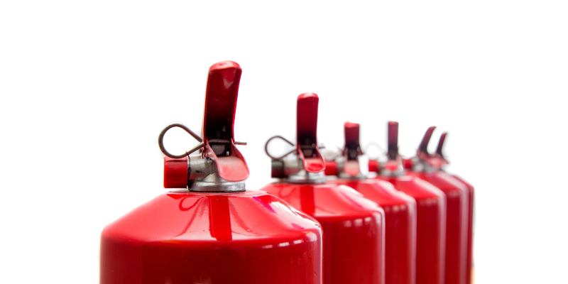 Fire extinguishers have been lined up in a row.