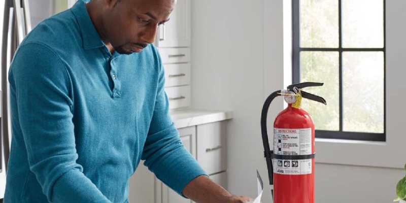 A man reading instruction for installing fire fighting equipment